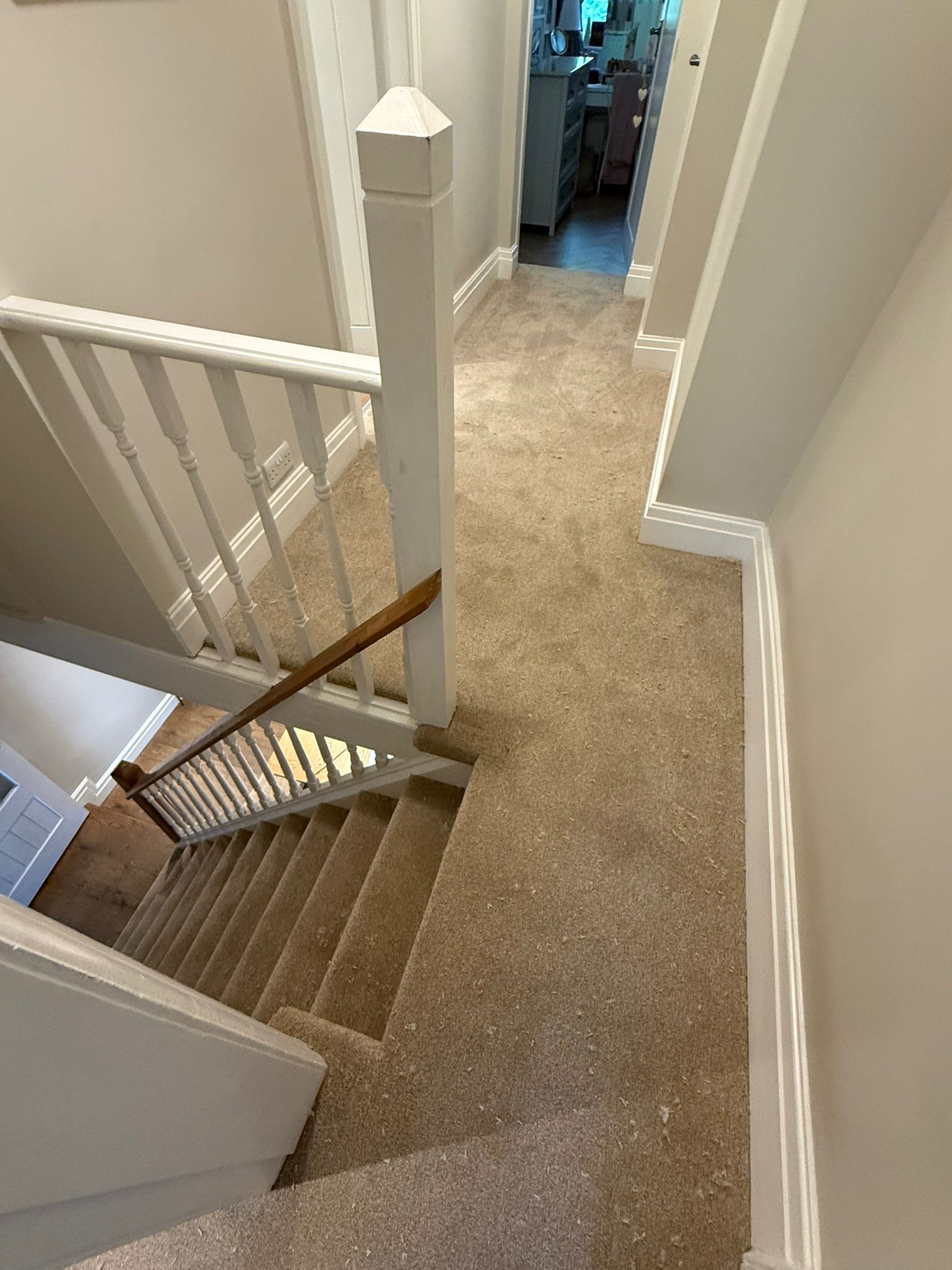 Finished carpeted staircase with glass balustrade